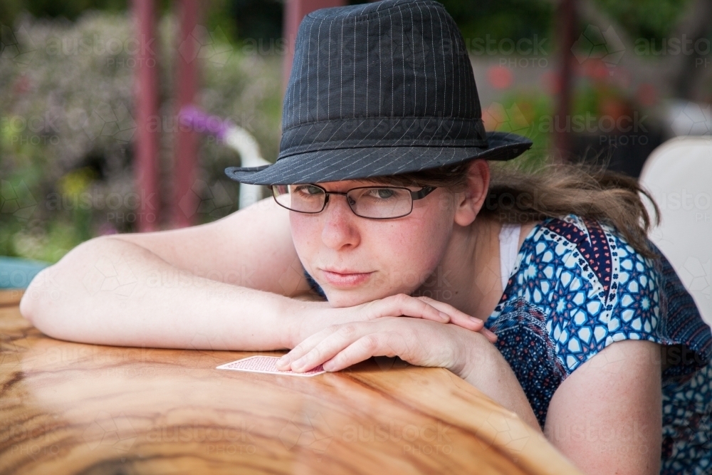 Fifteen year old girl watching a card game being played - Australian Stock Image