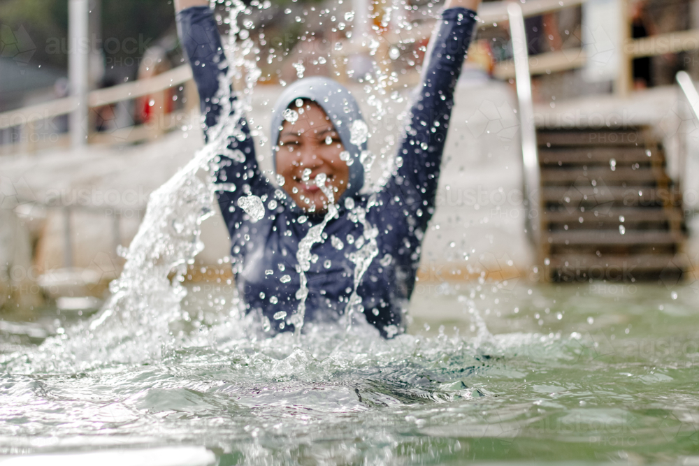 Female Splash Image of Filipina woman splashing water inside the tidal pool ...