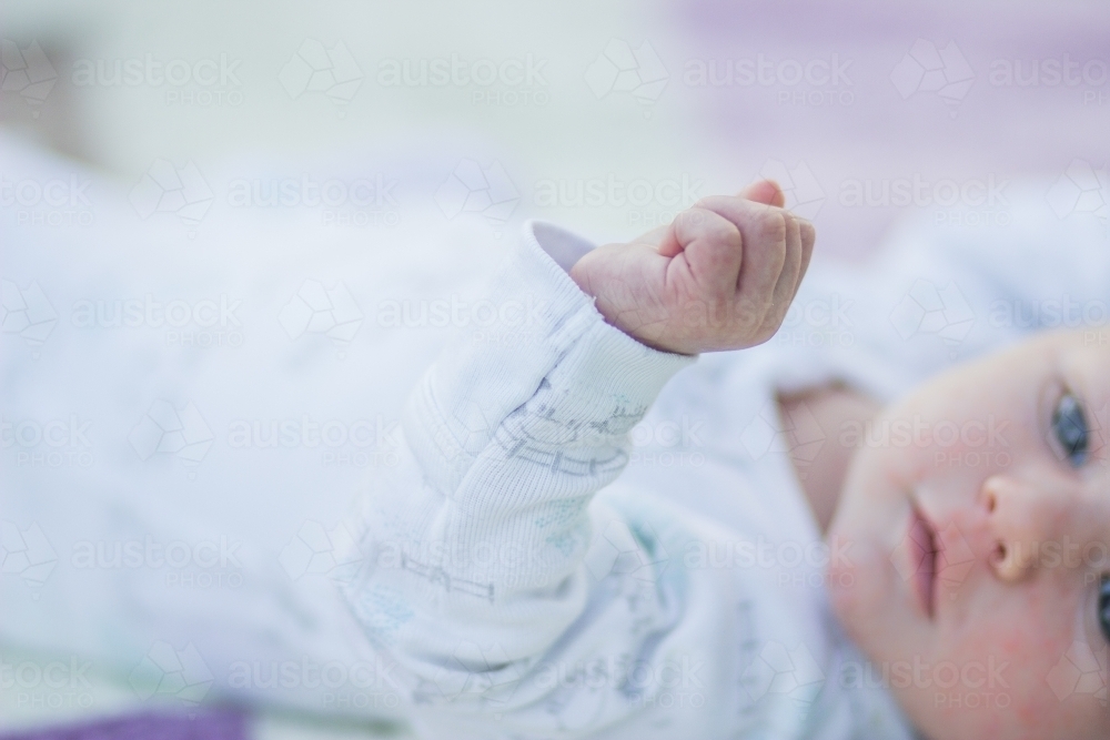 Fingers and hand of a newborn baby reaching out - Australian Stock Image