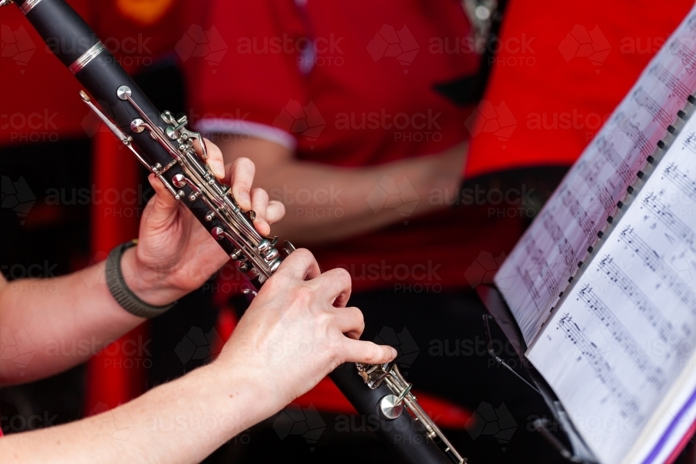 Image of Fingers of young player playing with local town band