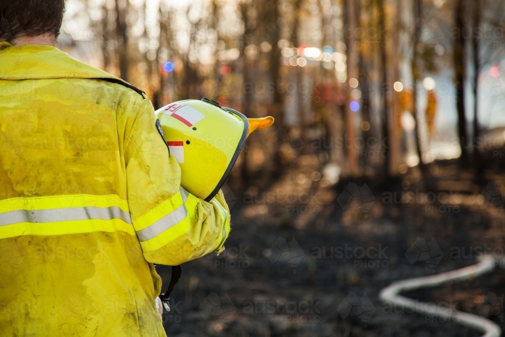 Fire and rescue man in fire brigade at grass fire emergency site - Australian Stock Image