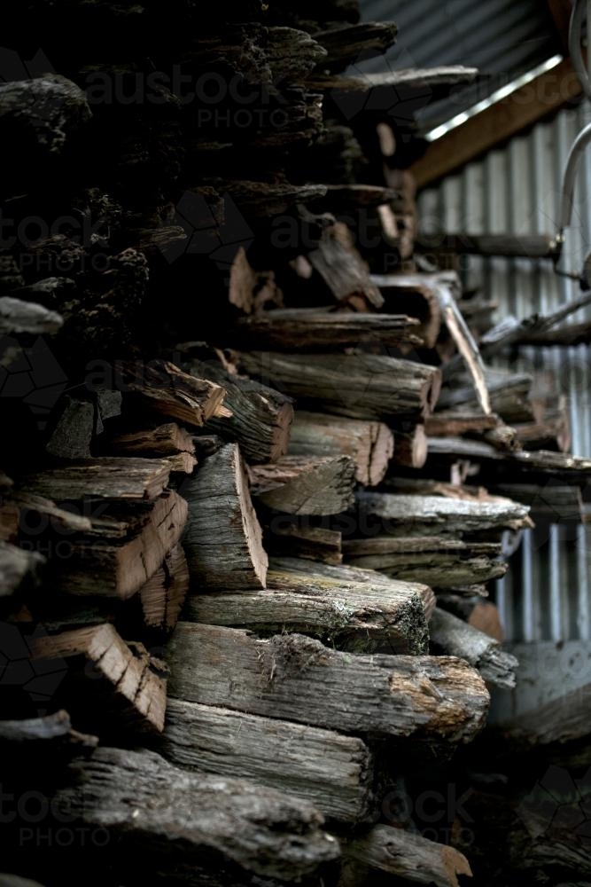 Fire wood stacked in shed - Australian Stock Image