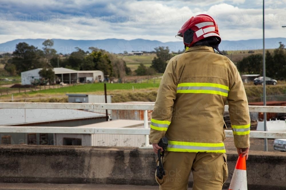 Firefighter setting up road cones for a roadblock - Australian Stock Image