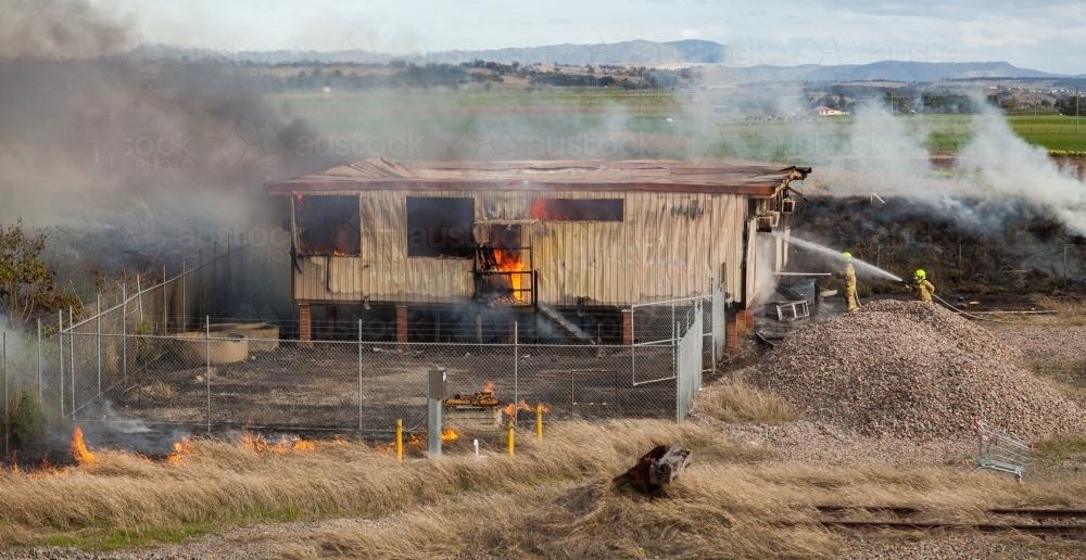 Firefighters putting out the flames of a burning shed - Australian Stock Image