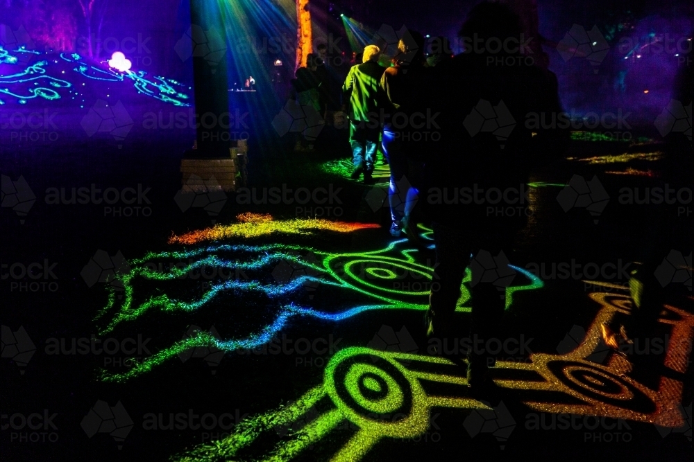 Firewalk display of aboriginal symbols in laser light display at night event - Australian Stock Image