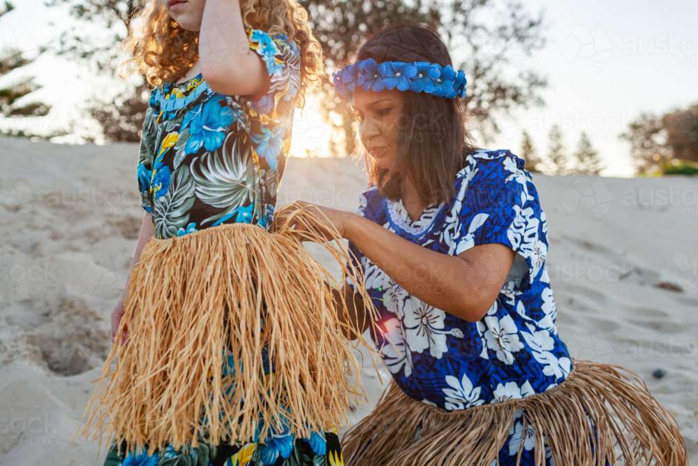 First Nations Australian Torres Strait Islander getting dressed for cultural performance on beach - Australian Stock Image