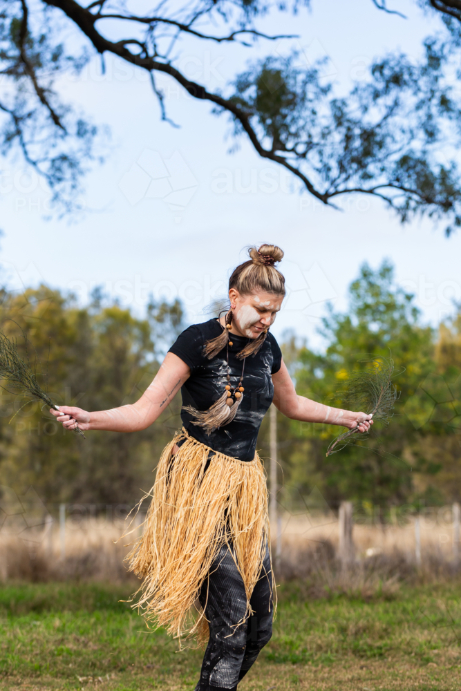 First nations Australian woman dancing to aboriginal music during welcome to country ceremony - Australian Stock Image