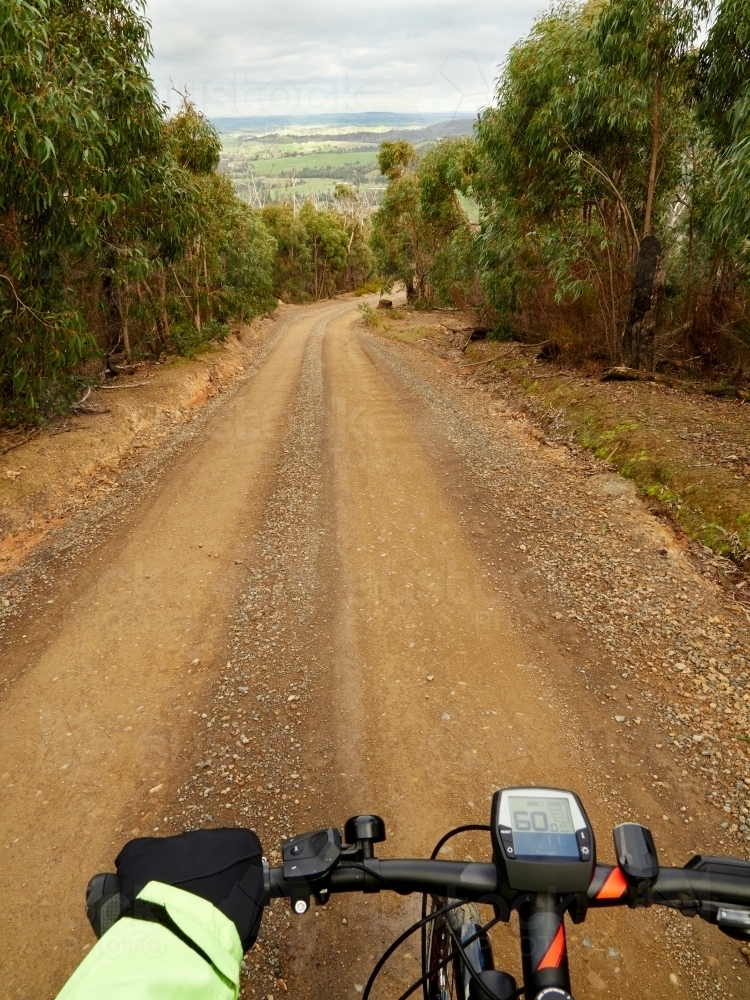 First Person View of Cyclist on Steep Gravel Road - Australian Stock Image