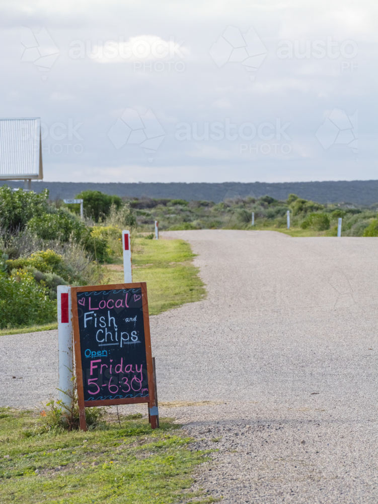 Fish and chip sign by side of quiet street - Australian Stock Image