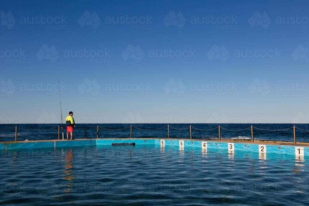 Fisherman at ocean pool - Australian Stock Image