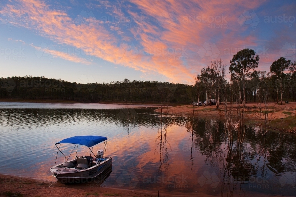 Fishing boat ready to go at sunrise over Lake Boondoomba - Australian Stock Image