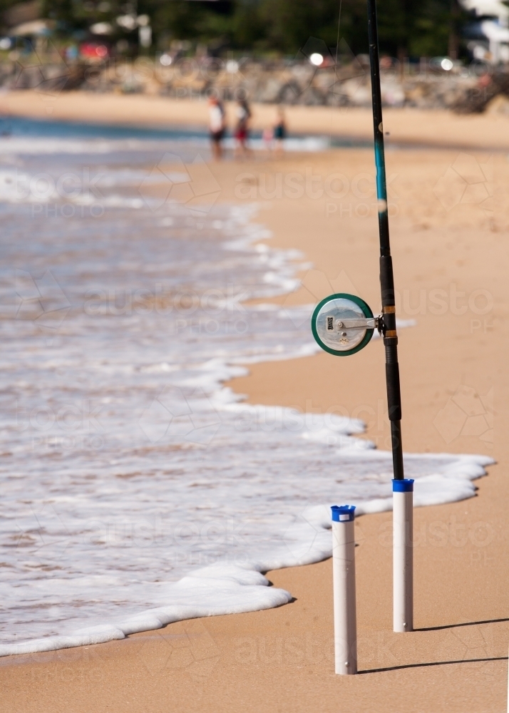 Fishing rod in holder on a beach - Australian Stock Image