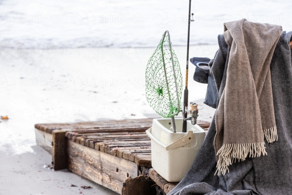 Fishing supplies on a fold-out chair on the beach - Australian Stock Image