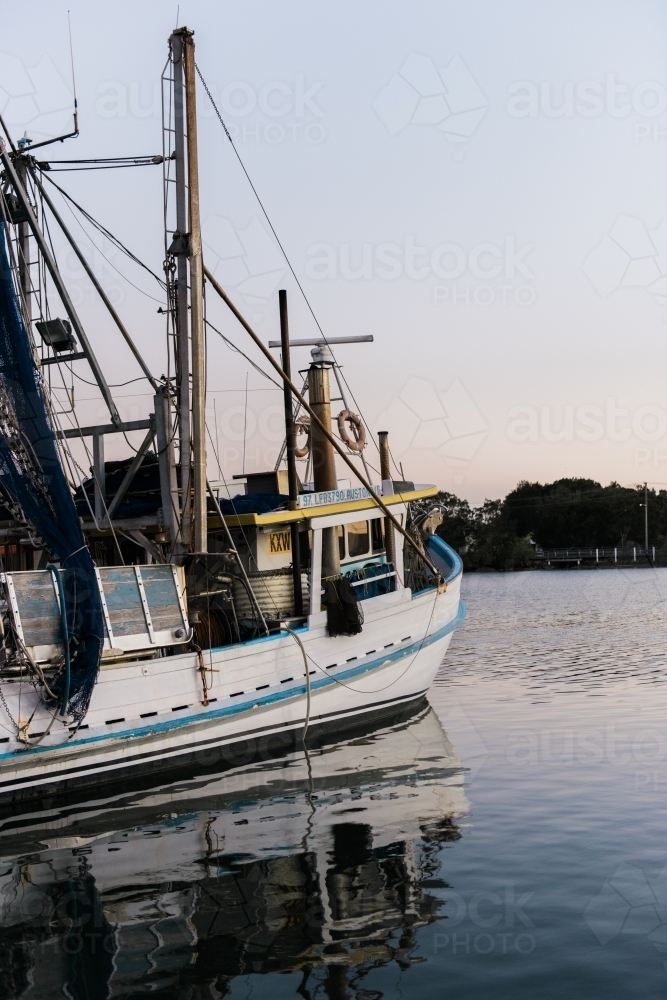 Fishing Trawler on a river at dusk - Australian Stock Image