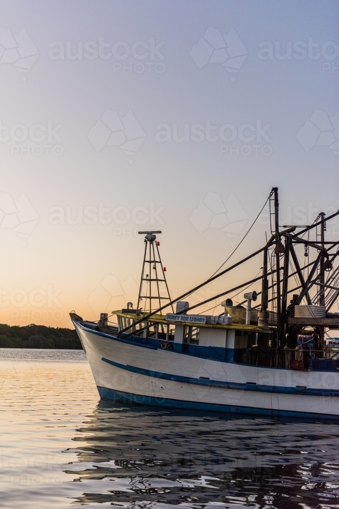 Fishing Trawler on a river at dusk - Australian Stock Image