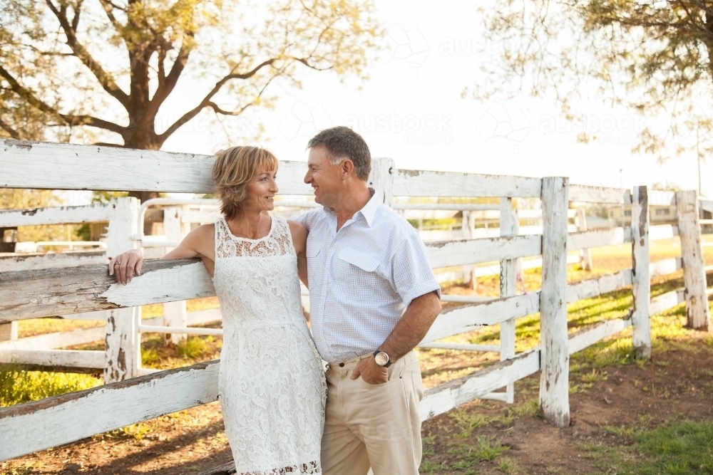 Fit happy middle aged couple looking at one another - Australian Stock Image