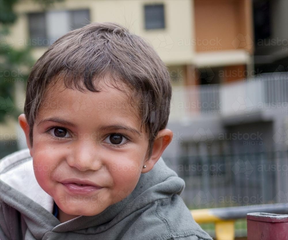 Five Year Old Aboriginal Boy on Blurred Urban Background - Australian Stock Image