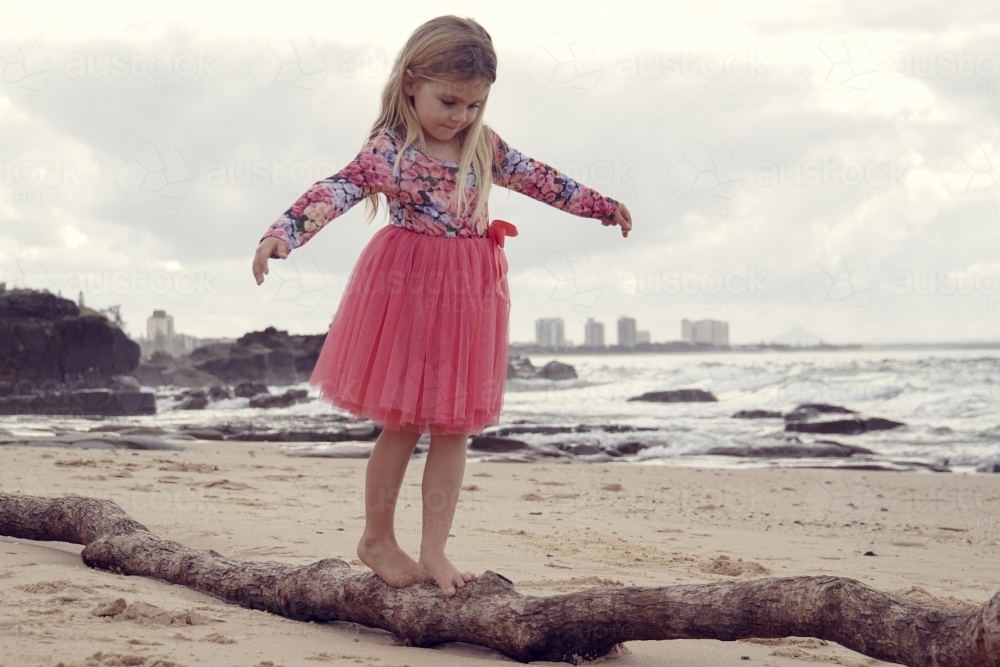 Five year old balancing on log - Australian Stock Image