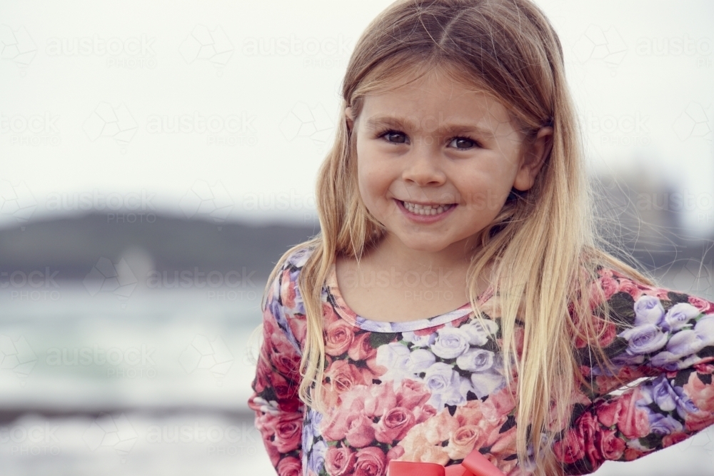 Five year old girl smiling at camera - Australian Stock Image