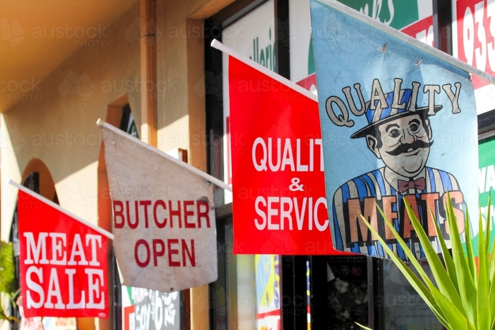 Flag signs on a butcher shopfront - Australian Stock Image