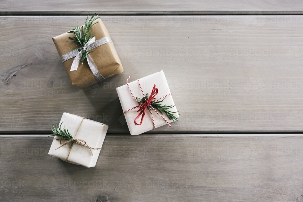 Flat lay of three Christmas gifts with stylish wrapping - Australian Stock Image