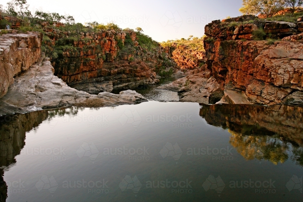 Flat pool flowing in Bells Gorge in the Kimberley - Australian Stock Image
