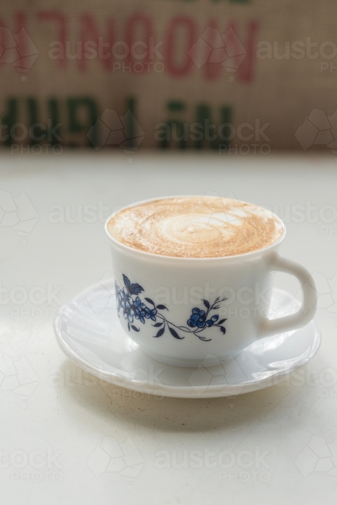 flat white coffee in a vintage tea cup - Australian Stock Image