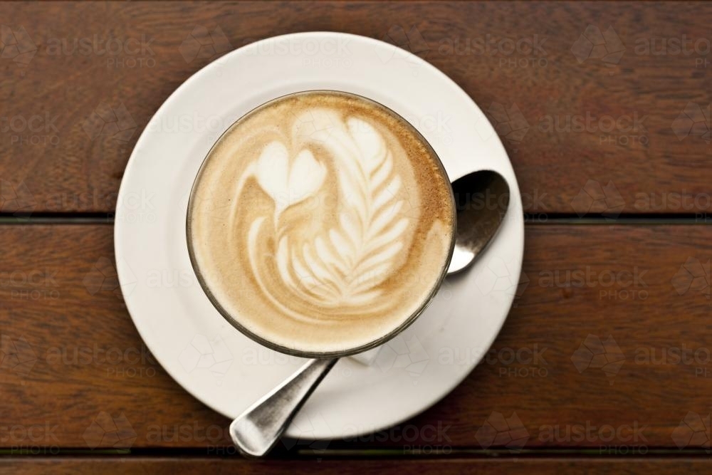 Flat white coffee with latte art featuring hearts and rosetta - Australian Stock Image