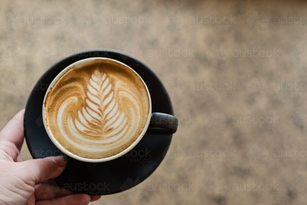 flat white with pretty coffee art rosetta - Australian Stock Image