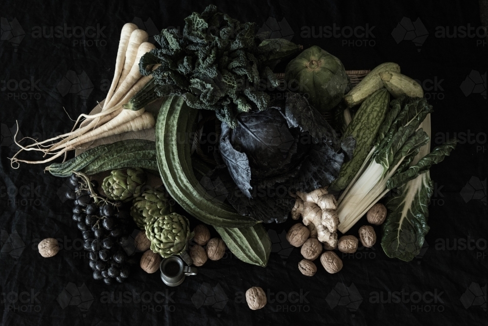 flemish style flat lay of fruit and vegetables with dark background - Australian Stock Image