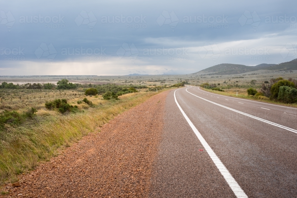 Flinders Ranges road with stormy sky - Australian Stock Image