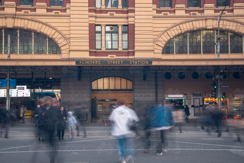 Flinders Street Station with pedestrians crossing the road - Australian Stock Image