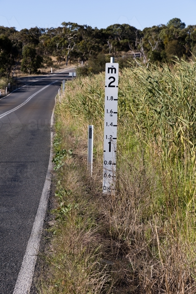 Flood Marker on Rural Road - Australian Stock Image