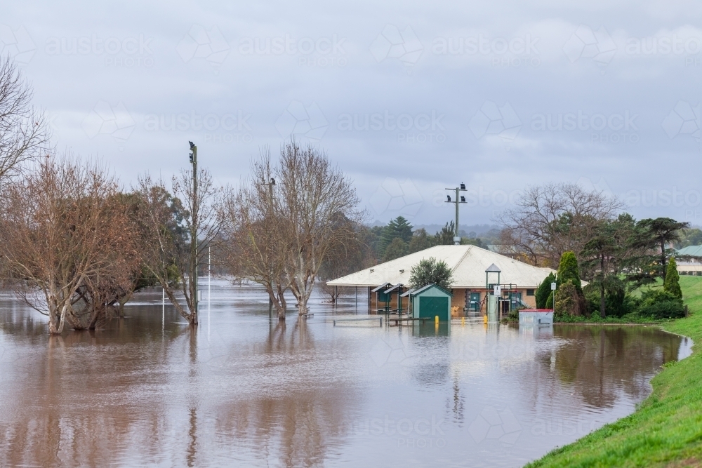 Flood natural disaster with water over park and building - Australian Stock Image