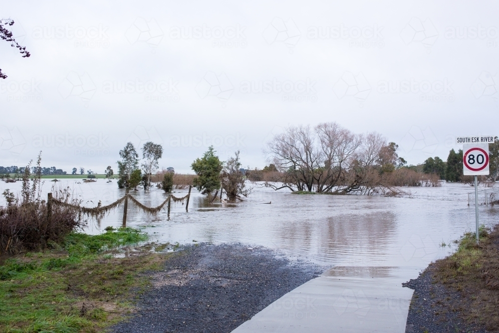 Flood waters covering road - Australian Stock Image
