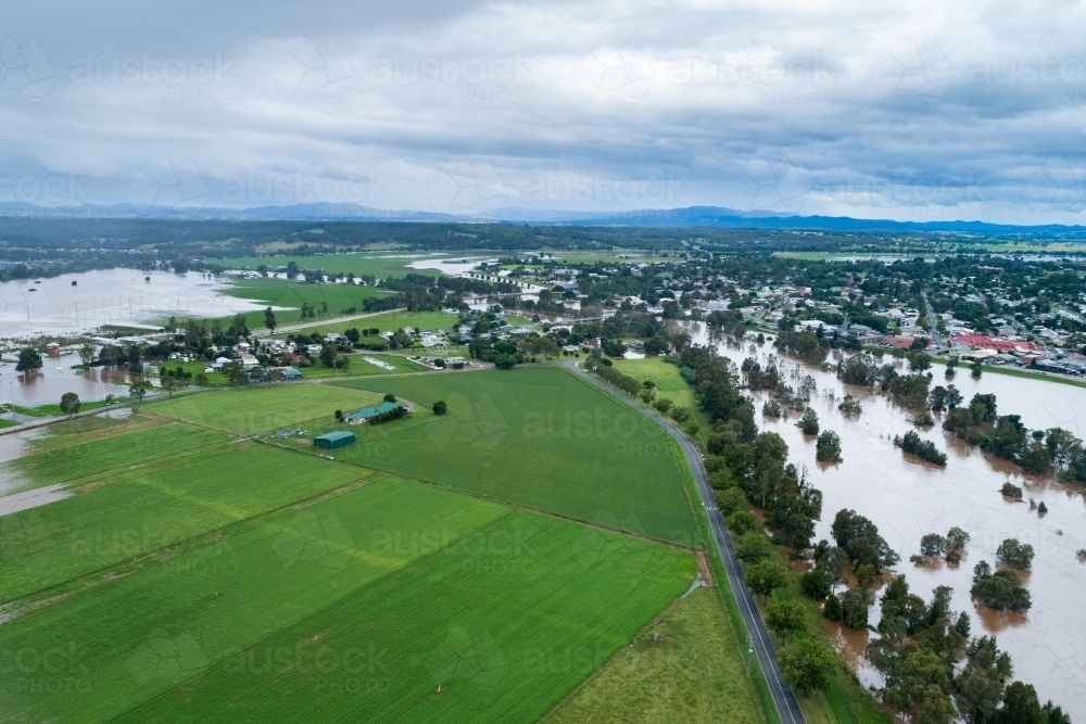 Flooding Hunter River and green farm paddock in Hunter Valley - Australian Stock Image