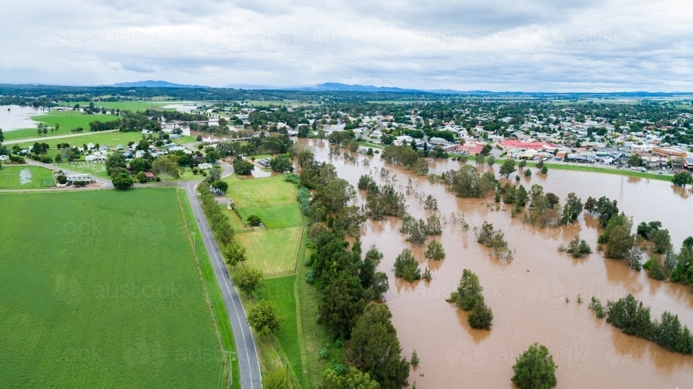 Flooding Hunter River and green farm paddock in Hunter Valley - Australian Stock Image