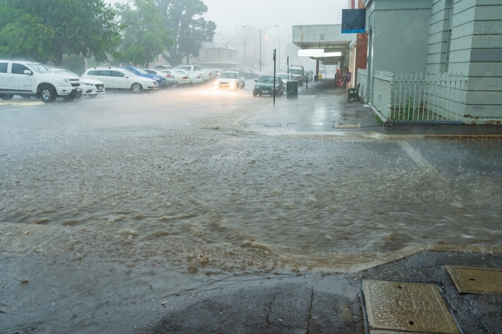 Flooding rain crossing a city street - Australian Stock Image