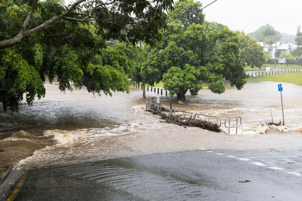 Floodwaters cover a bridge over the Ithaca Creek in the suburb of Red Hill in Brisbane - Australian Stock Image