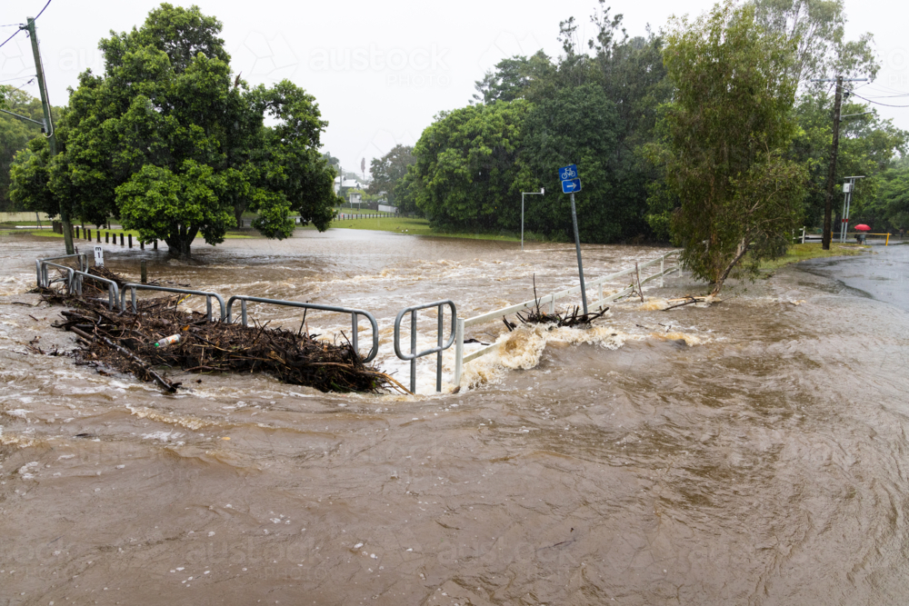 Floodwaters cover a bridge over the Ithaca Creek in the suburb of Red Hill in Brisbane - Australian Stock Image