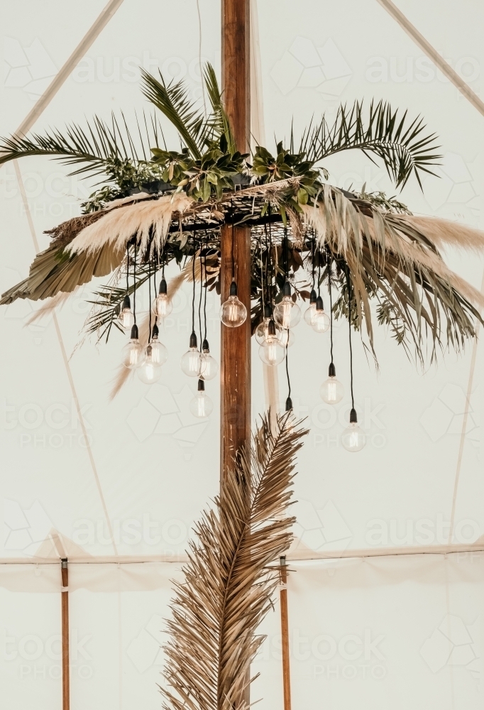 Floral decoration in a marquee with lighting. - Australian Stock Image
