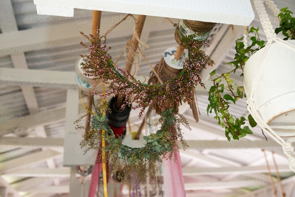 Floral flower crowns and ribbons hanging from the ceiling of a florist workshop - Australian Stock Image