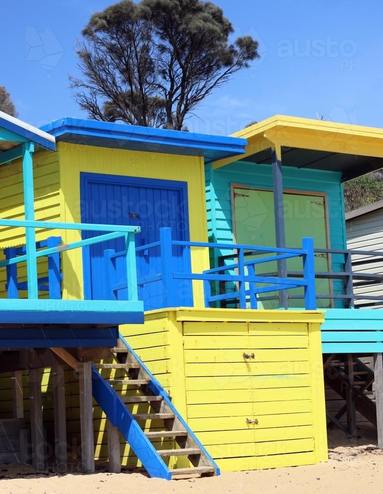 Fluro coloured blue and yellow beach boxes on a sunny day - Australian Stock Image