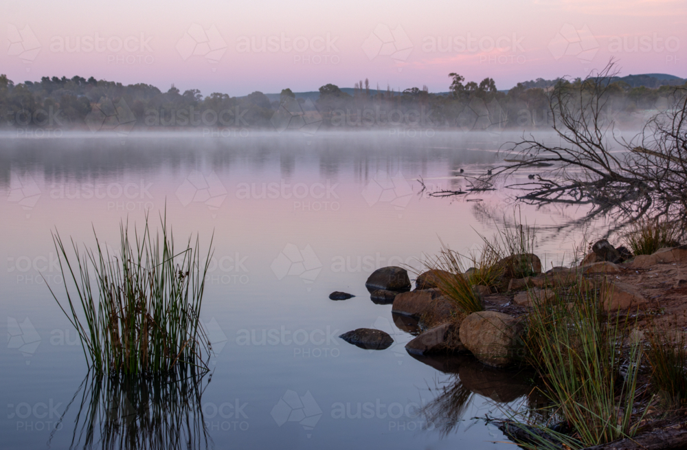 Fog rising off water at sunrise in regional NSW - Australian Stock Image