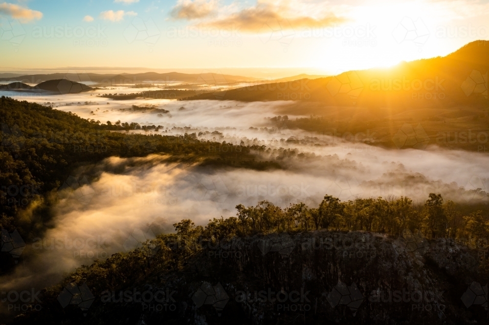 Foggy mountain landscape at sunrise - Australian Stock Image