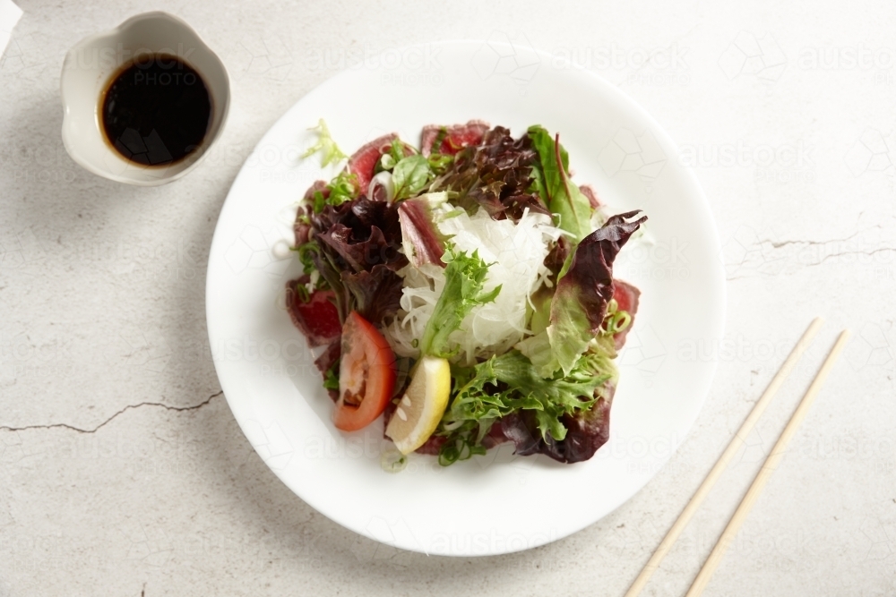 Beef tataki dish on table - Australian Stock Image