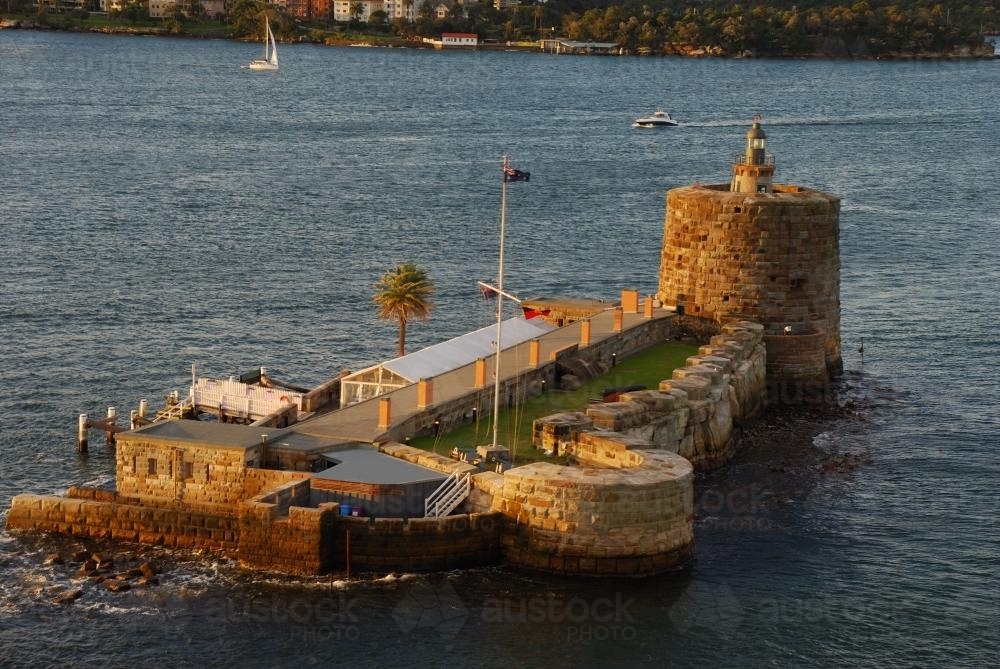 Fort Denison in Sydney Harbour with the light of the setting sun - Australian Stock Image