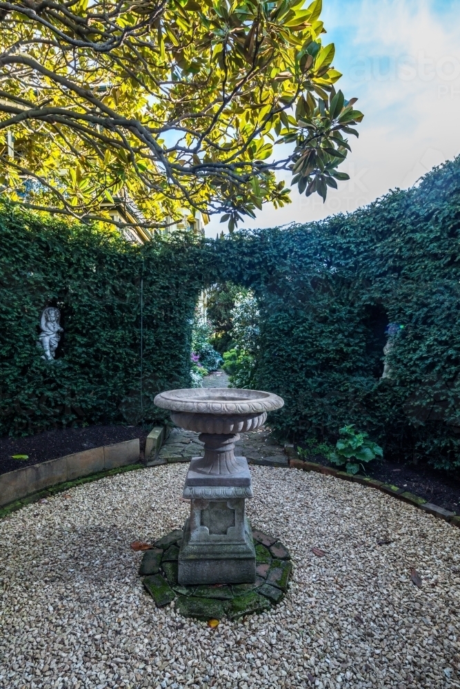 Fountain in hedged garden of historic Corinda accommodation in Hobart - Australian Stock Image