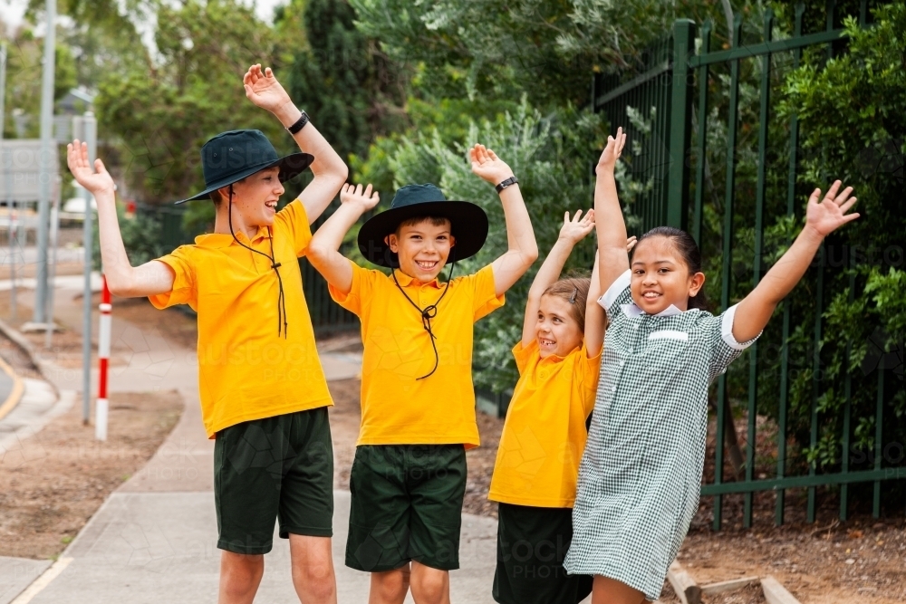Four primary school children celebrating end of term - Australian Stock Image