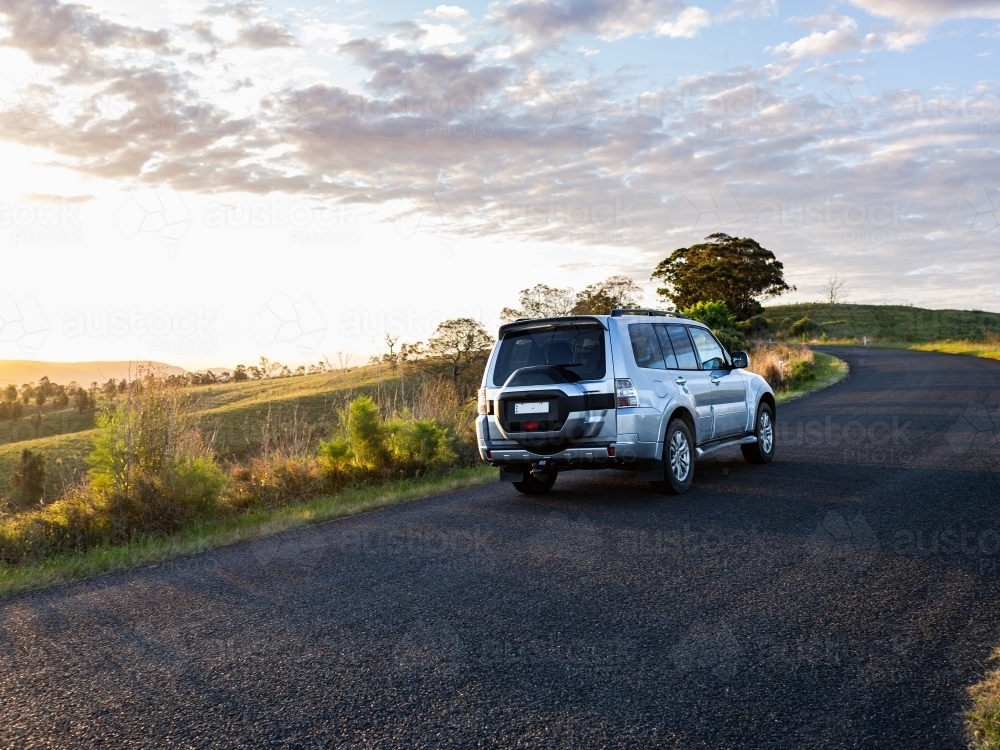 Image of four wheel drive car driving on country road trip adventure